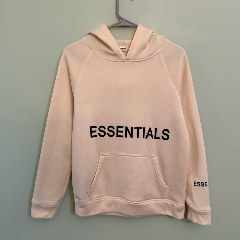 Hoodie with the‎ word essentials on the front size M